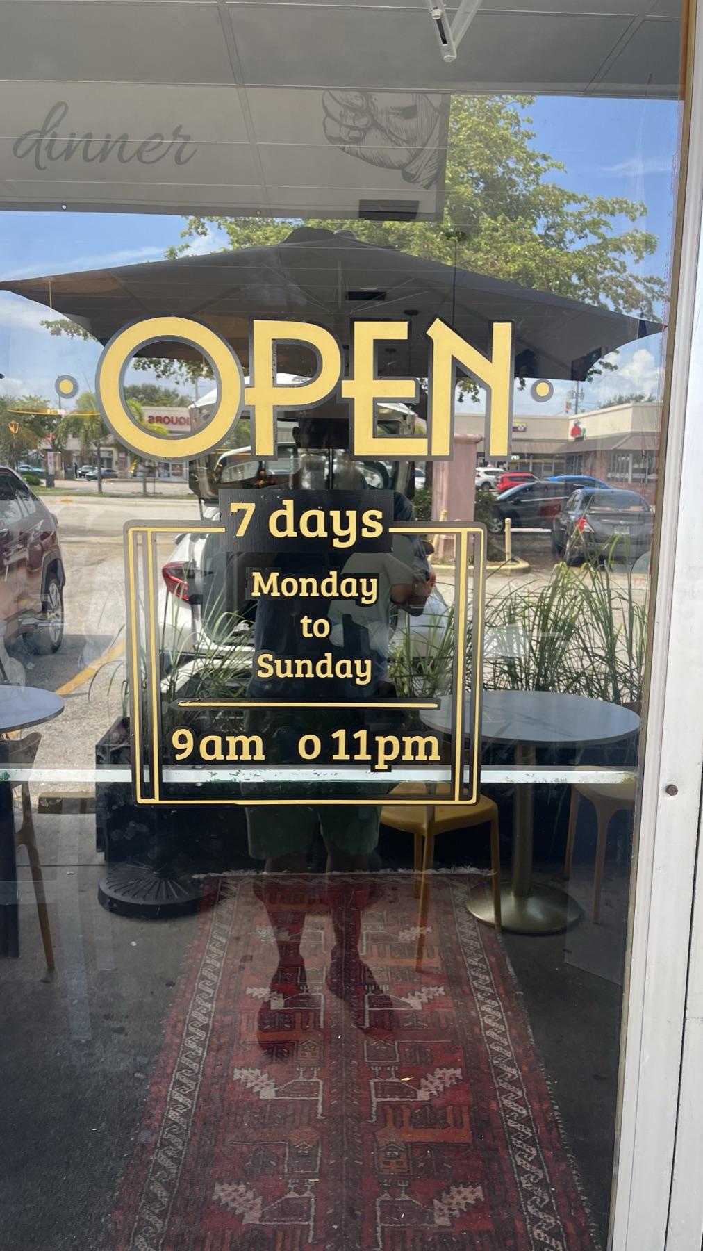 Gold door lettering with store hours